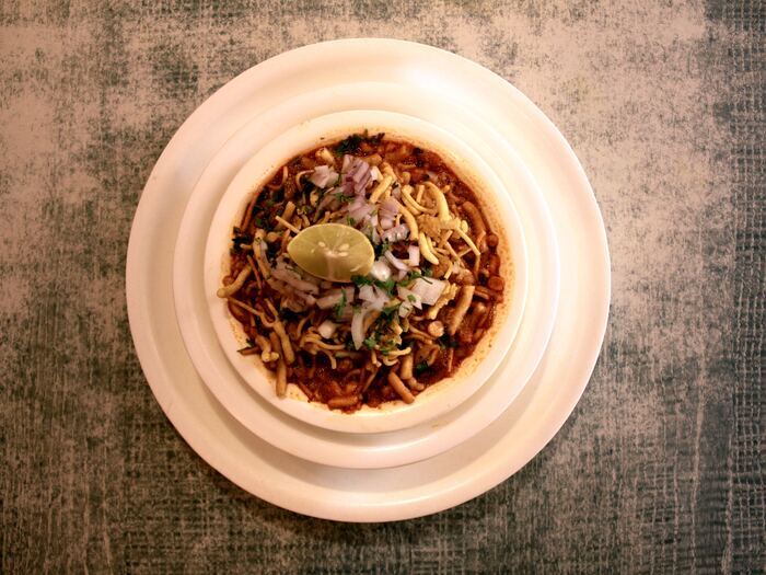 Spiced usal curry topped with crunchy sev, onion and lime